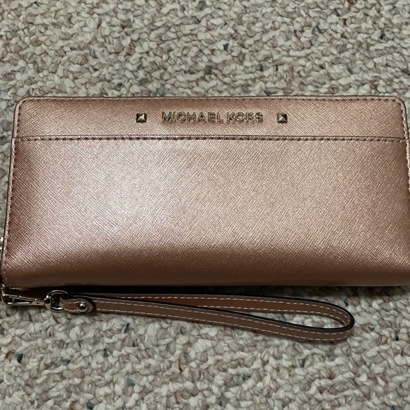 MICHAEL Michael Kors Handbags - Michael Kors shiny pink/peachy colored wristlet wallet.